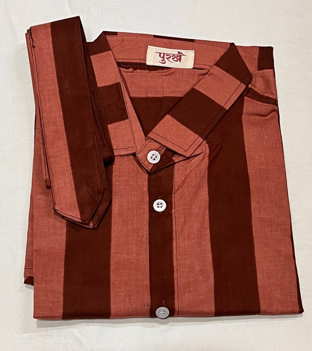 The Striped Shirt in Mocha, folded, with the Purkhe label