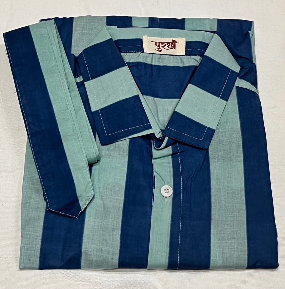 The Striped Shirt in Blue, folded, with the Purkhe label